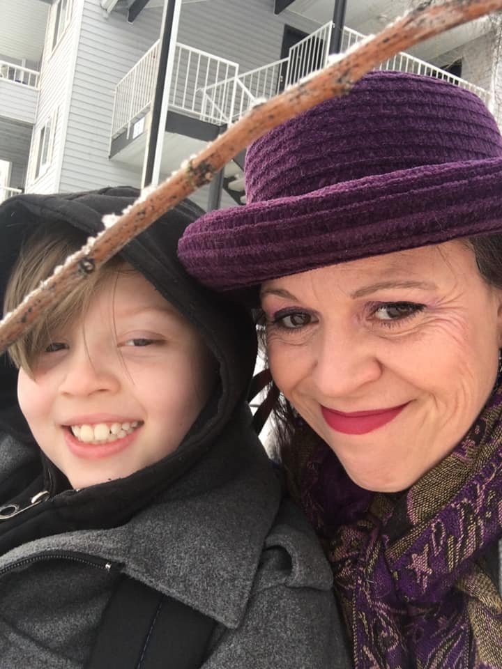 Kimberly Gypsy LoSavio smiling with her son outdoors.